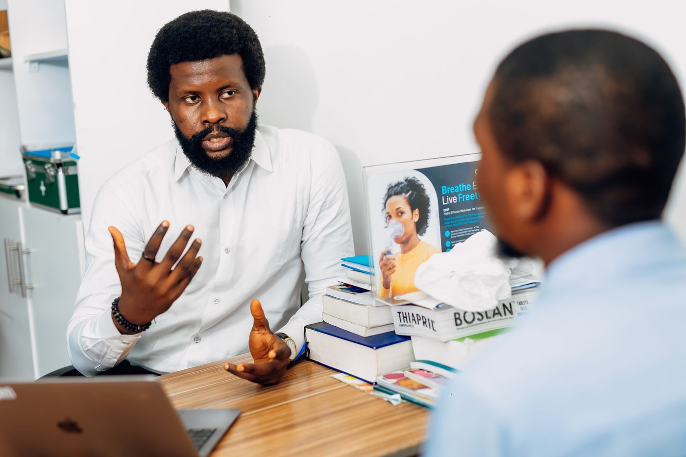 A doctor explaining health information to a patient across a desk